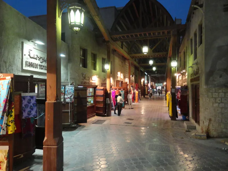 The covered Bur Dubai Textile Souk lit up at dusk